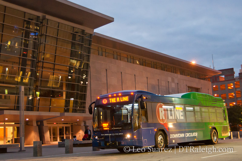 An R-Line bus in front of the Raleigh Convention Center