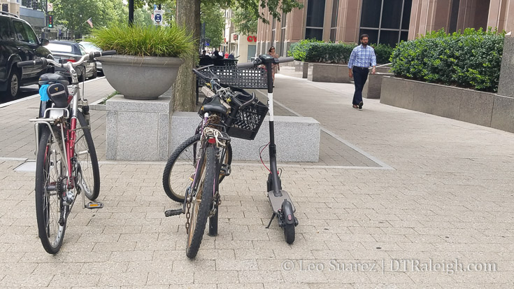 Bird scooter parked at a bike rack on Fayetteville Street.